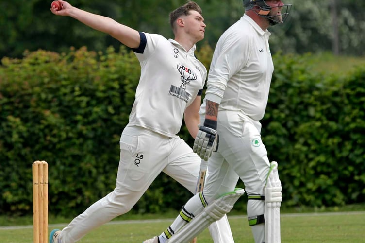 Liam Barrow bowls for Over Stowey with Ashbrittle's Mark White looking on. 