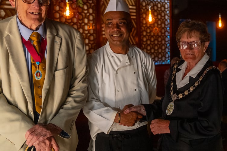 Mayor of Wellington, Cllr Janet Lloyd (right) with a member of the Wellington Tandoori kitchen team (middle), and her husband Ian (left)