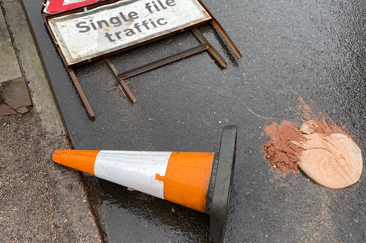 Signage indicating the temporary traffic restrictions and safety measures has toppled since April