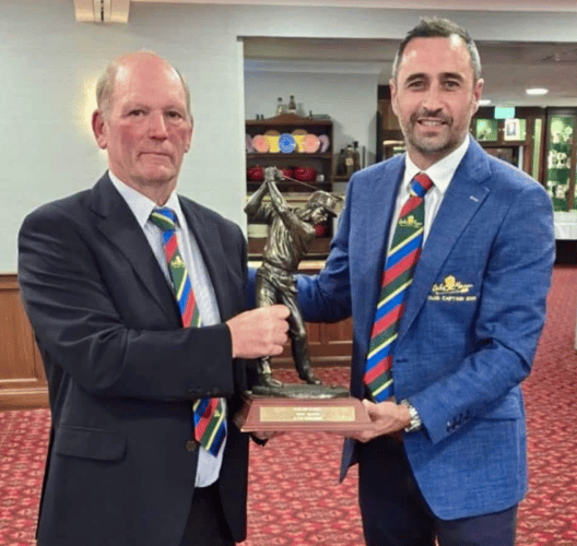 Club captain Richard Goodman (right) presents the winners' trophy to Graham Salway, captain of Ex-Captains