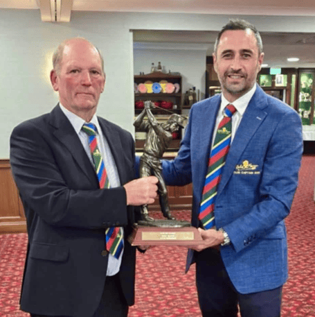Club captain Richard Goodman (right) presents the winners' trophy to Graham Salway, captain of Ex-Captains
