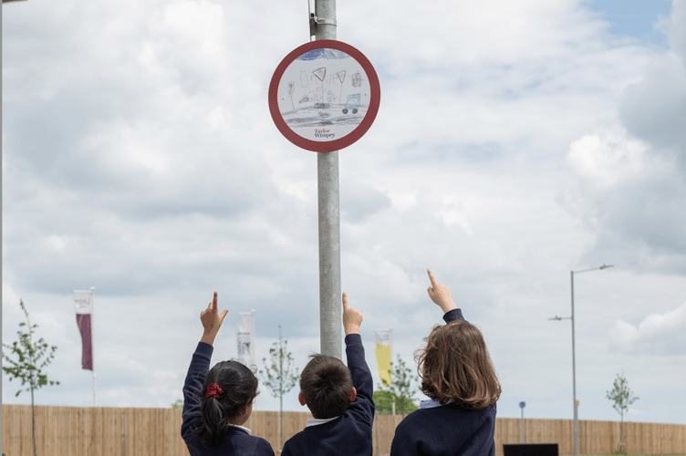 Orchard Grove Primary pupils with the winning speed sign, now displayed at Taylor Wimpey's Orchard Grove.