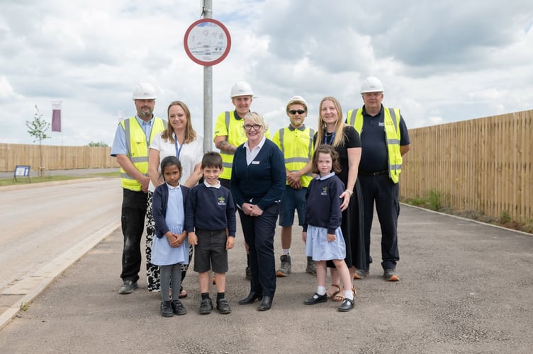 Orchard Grove Primary pupils see the installation of the winning speed sign, now displayed at Taylor Wimpey's Orchard Grove.