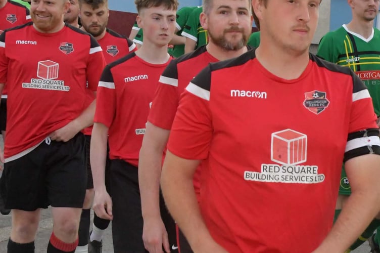 Arron Campbell leads out Welington Reds at the Rowbarton Charity Cup final at Taunton