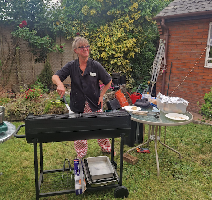 Old Vicarage chef Donna Munson serving a barbecue for Wellington Abbeyfield tenants and guests after their homes were saved from closure.