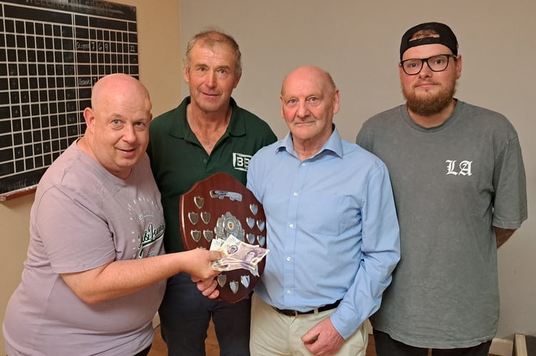David Derrick, chairman of Wellington Ex-Services Skittles League, presents Scuppas with the triples shield