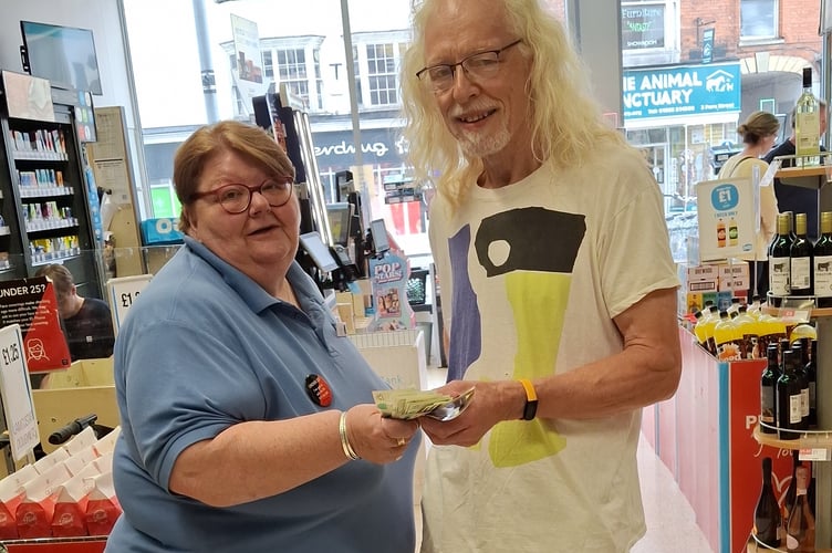 Sure/Beacon Centre representative collecting £275 raised earlier in the year