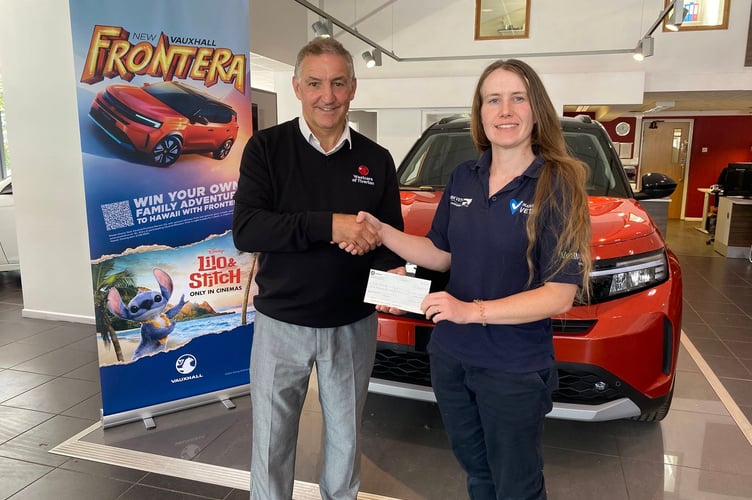 Kt English-Baillie receives a cheque from Westcars Tiverton to support her cancer charity fundraiser