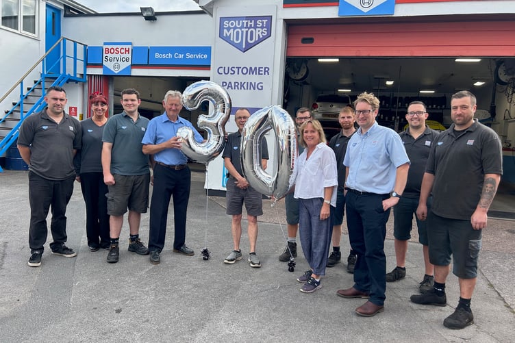 Andrew Webber (centre) with managing director Jon a’Court-Wills, Jon’s wife Sophie and staff at South Street Motors