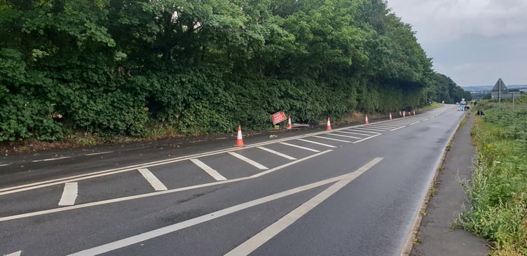 Part of the A38 remains coned off pending resurfacing work following a car crash in which five young men were injured.