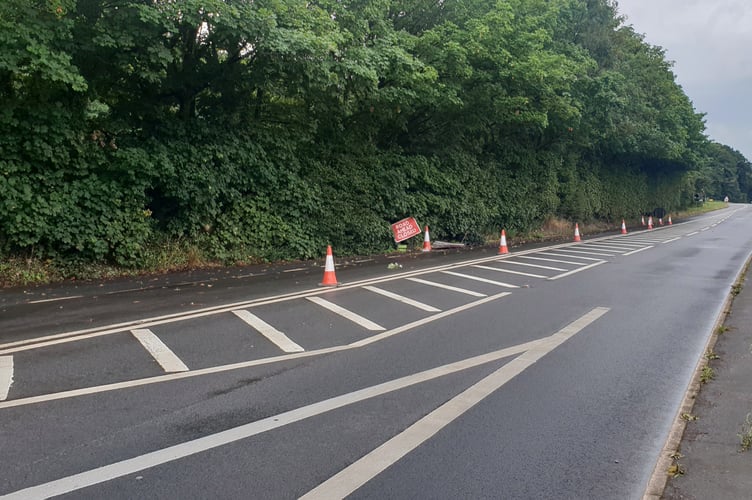 Part of the A38 remains coned off pending resurfacing work following a car crash in which five young men were injured.