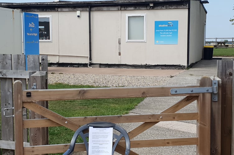 A notice of company liquidation can be seen outside the Skydive Buzz offices at Dunkeswell Airfield.