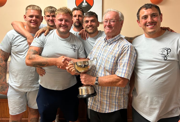 Peter Bird (second right) presents the cup to Ryan Marke and his One Night in Bangkok teammates.