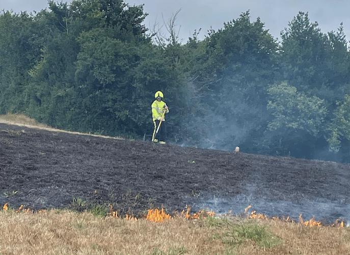 A Wiveliscombe firefighter tackling a grass fire on the Quantock Hills. PHOTO: DSFR.