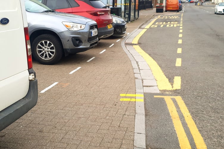 The dotted white line shows where cars should park parallel to Wellington's High Street, and not herringbone style as shown in the photograph taken on Sunday.