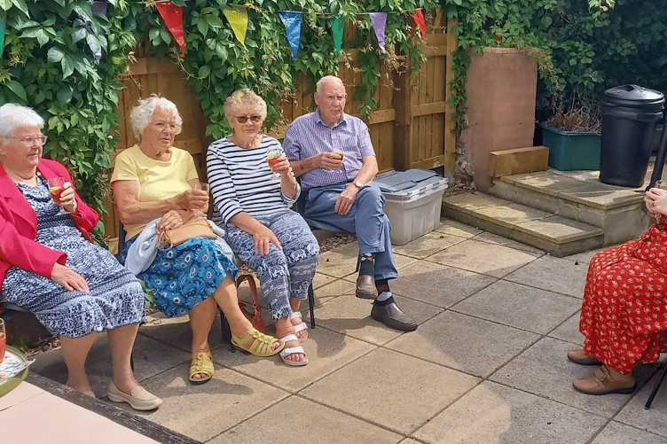 Hemyock residents (left to right) Mary Hawkins, Mary Beard, Annette and Richard Hart, with Janice Bawler, enjoying a drink of Pimms in the garden.