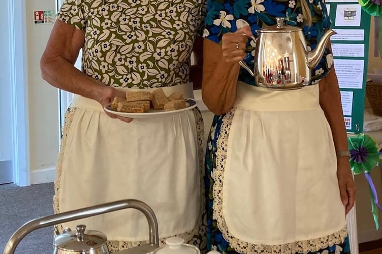 Members Christine Warn and Gill McGoun serving tea and sandwiches