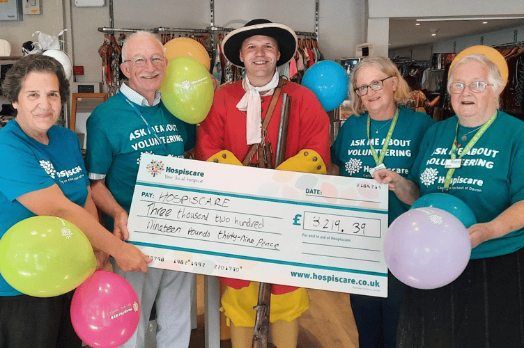 Mark Vaughan presenting a cheque to Hospiscare following a 100-mile re-enactment march