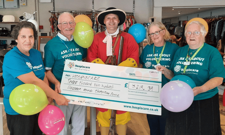 Mark Vaughan presenting a cheque to Hospiscare following a 100-mile re-enactment march