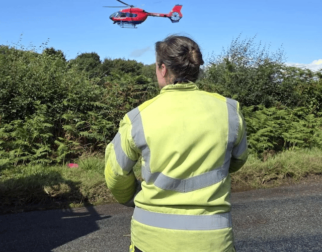 The Devon Air Ambulance landing on the Blackdown Hills to attend a serious road crash in Churchinford.
