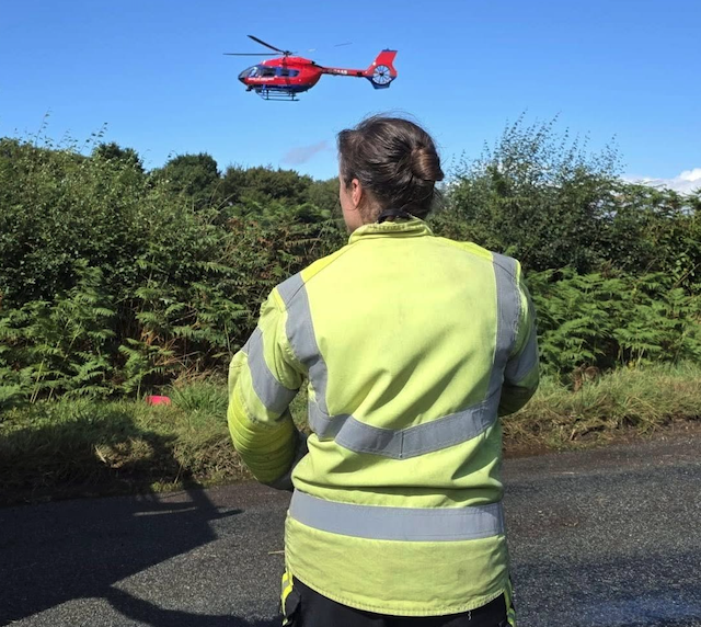 The Devon Air Ambulance landing on the Blackdown Hills to attend a serious road crash in Churchinford.