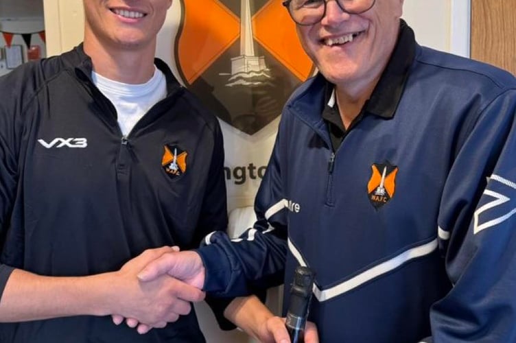Wellington's Player of the Match Nathan Byrne receives his award from club chairman and interim manager Mike Hall on behalf of match sponsor A J Shire Electrical and Solar Services.