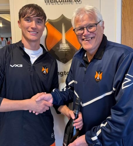 Wellington's Player of the Match Nathan Byrne receives his award from club chairman and interim manager Mike Hall on behalf of match sponsor A J Shire Electrical and Solar Services.