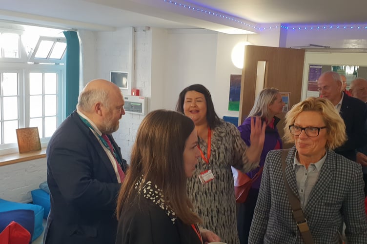 Somerset Council leader Cllr Bill Revans (left) chats to Wellington Town Council staff and guests at the opening of the Kings Arms community hub.
