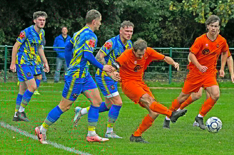 Action from Wellington's home match against Paulton Rovers last Saturday.