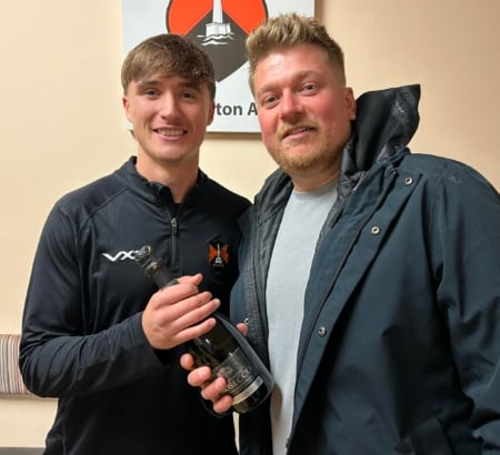 Wellington's Player of the Match Nathan Byrne receives his award from Barry Hamilton of Magenta Alarm and Security Systems Ltd, who sponsored the game.