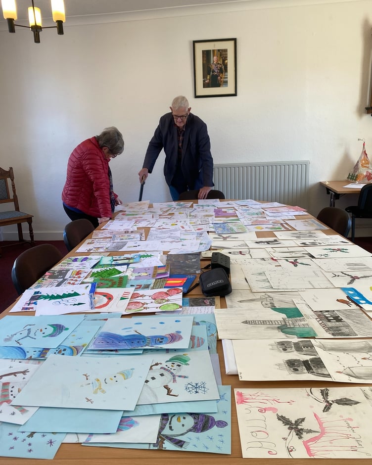 Wellington Mayor Cllr Janet Lloyd and her consort, husband Ian, look through hundreds of entries for her Christmas card competition.