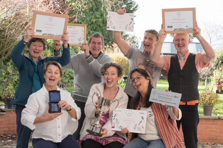 The Transition Town Team celebrating their win. Back row: Diana Fox, Steward Hill, Philip Knowlman, Stephen Gregory. Front row: Anita Corbin, Helen Gillingham, Anita Roy