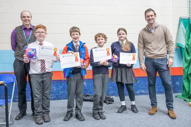 Minehead Middle School pupils with Peter Buckingham, Wellington School Maths Challenge Organiser (left) and Alex Battison, Wellington School Headmaster (right).