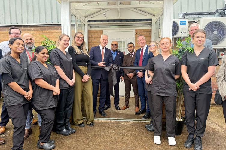 Gideon Amos MP cuts the ribbon with Jonathan Higman, Chief  Executive of NHS Somerset, and guests and members of staff at Wellington Dental Care.