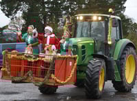 Father Christmas arrives by tractor to farm shop