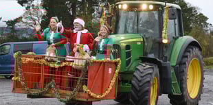 Father Christmas arrives by tractor to farm shop