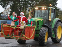 Father Christmas arrives by tractor to farm shop