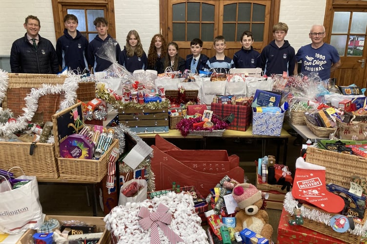 The array of hampers with pupils from Wellington School with Mr Milne (left) teacher and coordinator of the hamper project and Andy Felix (right) the Manager of the Best Before Food Store. 