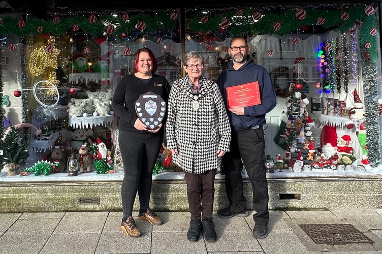 H T Perry & Son & Granddaughter with their award winning Christmas shop window.