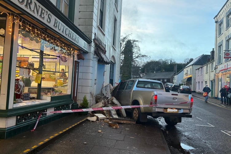 A crashed vehicle can be seen embedded in the front of a Wiveliscombe house on Thursday.
