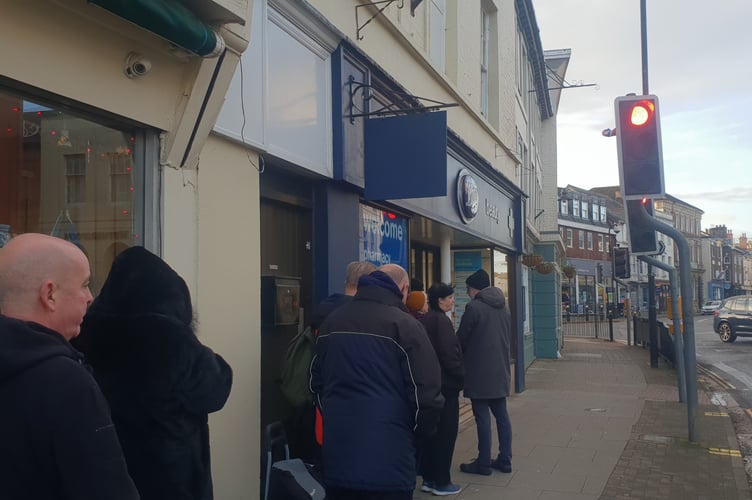 People queuing outside the Boots town centre pharmacy in Wellington before it opened for the day.