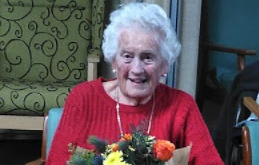 Betty Bennet with a bouquet presented to her to mark her 95th birthday.
