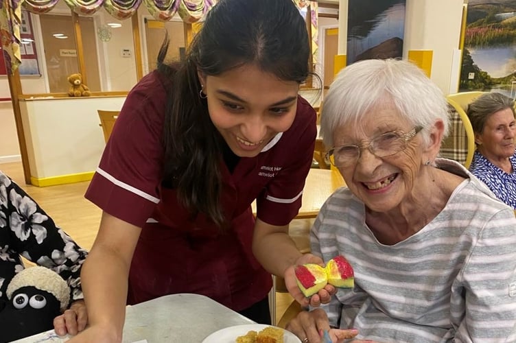Activities assistant Missel Sera Gigo with resident Frances Eales.