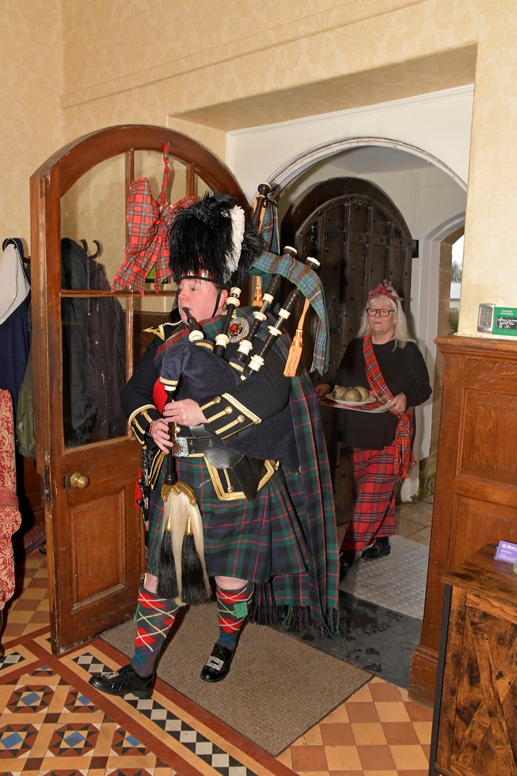 Piper Jen Botterill piping in the haggis with assistance of Helen Hill for Nynehead Court's Burns lunch.