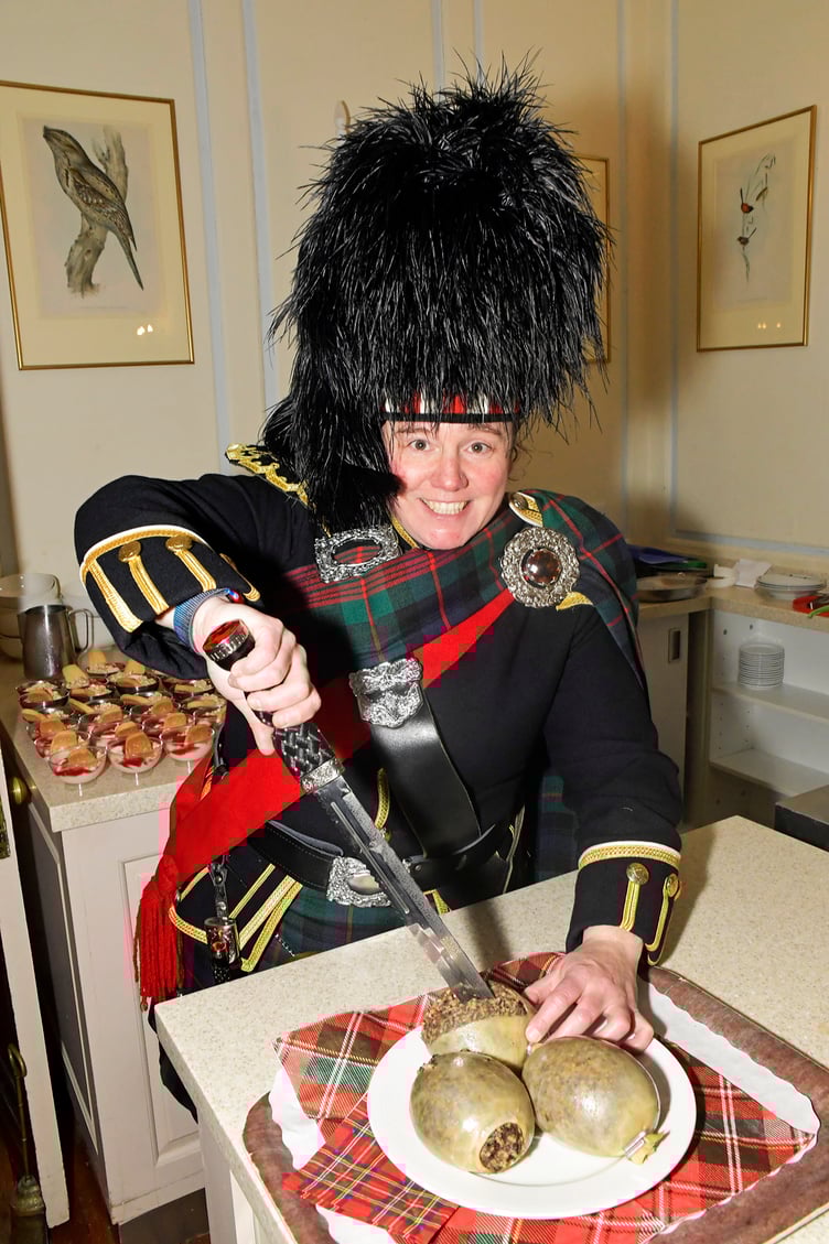 Piper Jen Botterill, from Glasgow, with the Nynehead Court haggis for a Burns lunch.
