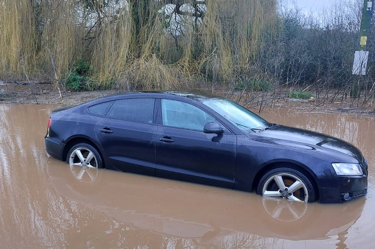 A car on the A38 has been affected by flooding.