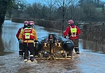 Woman rescued after car stuck in floodwater