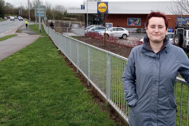 Labour by-election candidate Beth Hill at Wellington's Lidl supermarket where hedgerows to screen the store are still missing after three years.