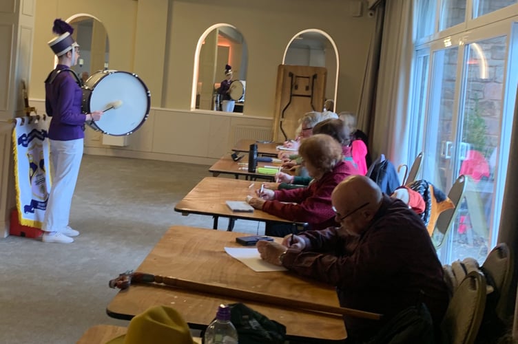 Laura, from Wellington Majorettes, poses for sketches by members of Wellington Rugby Club Art Group.