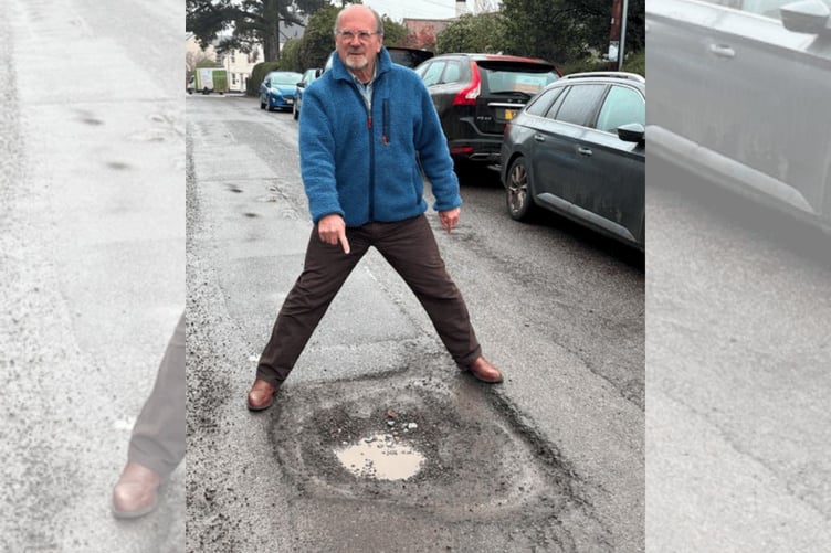 Wellesley Park resident and Wellington town Cllr Keith Wheatley with a lunar crater of a pothole outside his home.